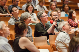 Participants from the audience asking questions